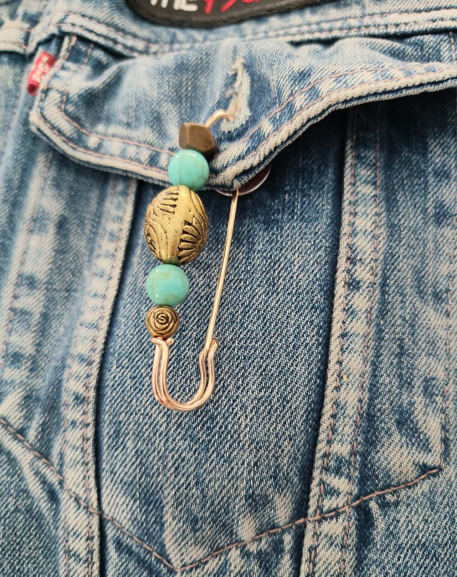 Biker safety pin attached to a denim vest